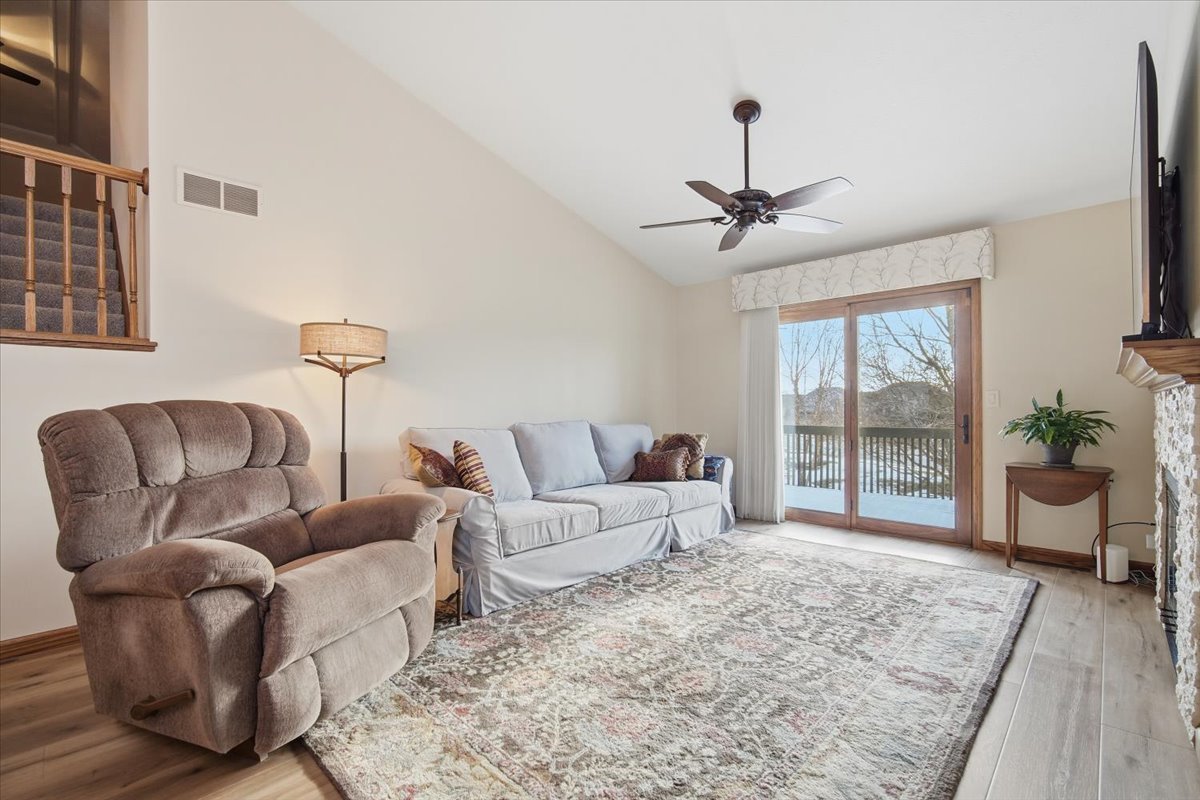9 Spruce Court Bloomington, IL 61704 - Photo 7 of 42 a living room with furniture ceiling fan and a rug