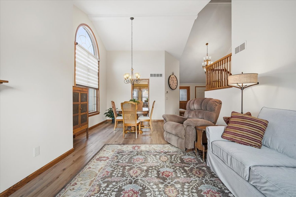 9 Spruce Court Bloomington, IL 61704 - Photo 9 of 42 a living room with furniture a rug and white walls