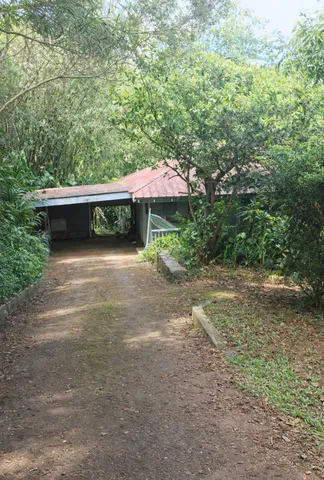 a view of a house with a yard and sitting area