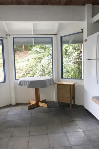 a room with a large window and a rug