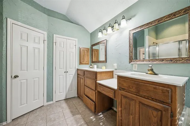 a spacious bathroom with a granite countertop sink mirror and