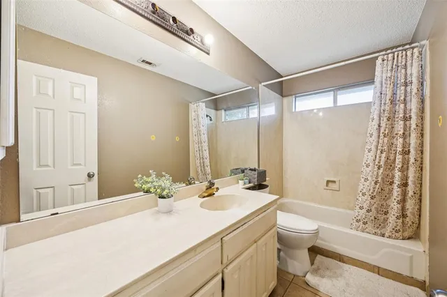a bathroom with a double vanity sink toilet and shower
