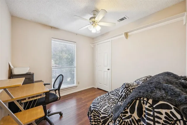 a bedroom with a bed and a chair