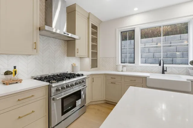 a kitchen with cabinets appliances and a window