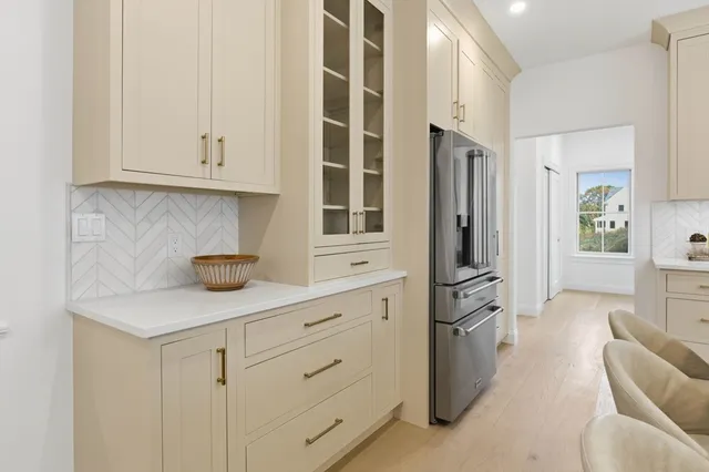 a kitchen with stainless steel appliances white cabinets and a refrigerator