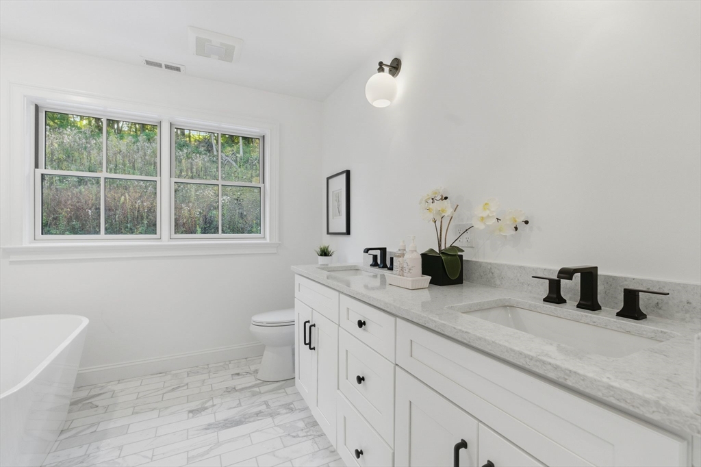 161 Bridge Street Hamilton, MA 01982 - Photo 27 of 42 a bathroom with a double vanity sink and a mirror