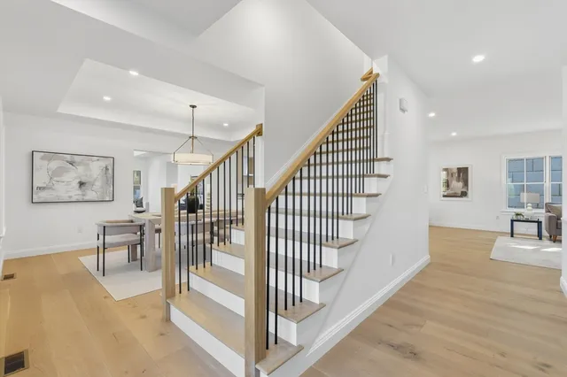 a view of entryway and hall with wooden floor