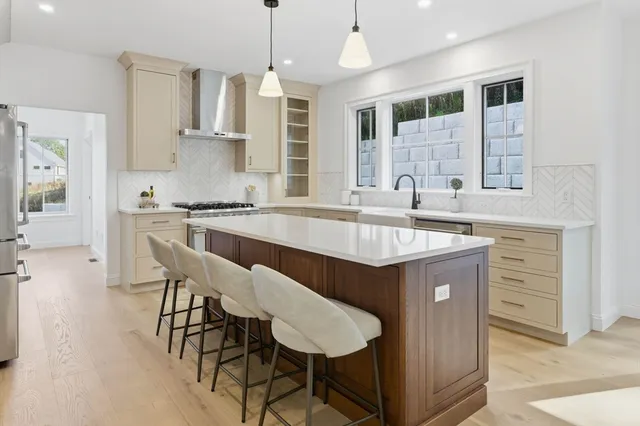 a kitchen with a table chairs sink and cabinets