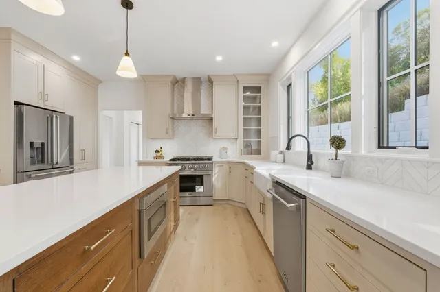 a kitchen with a sink stove and cabinets