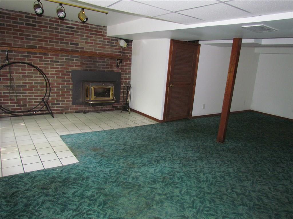 392 Kriess Road Renfrew, PA 16053 - Photo 10 of 24 Lower family room with wood burning fireplace