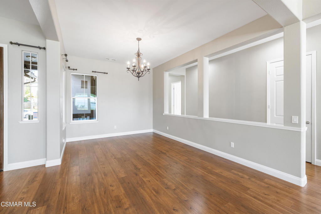 4920 Corral Street Simi Valley, CA 93063 - Photo 11 of 54 a view of an empty room with wooden floor and a window