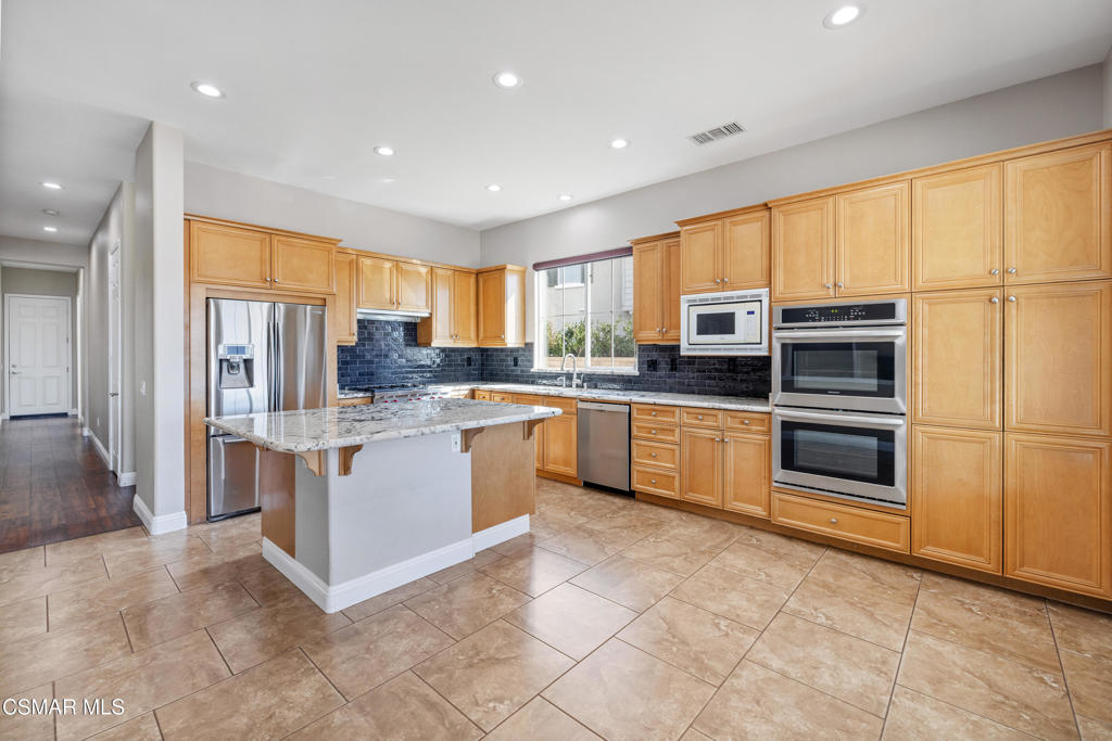 4920 Corral Street Simi Valley, CA 93063 - Photo 13 of 54 a kitchen with stainless steel appliances a stove sink and microwave