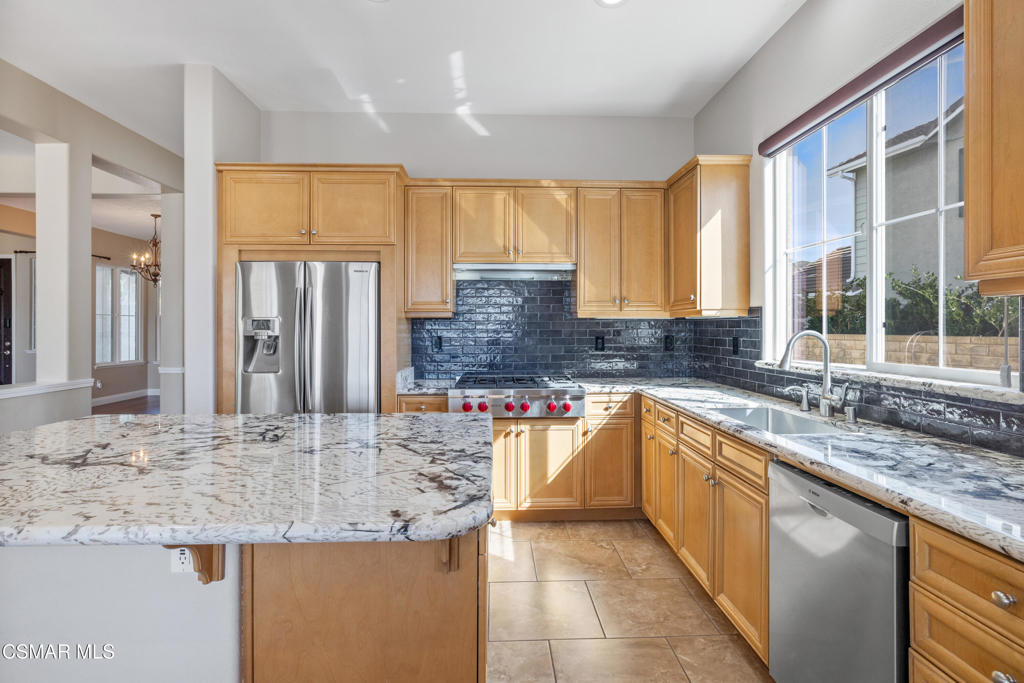 4920 Corral Street Simi Valley, CA 93063 - Photo 14 of 54 a kitchen with stainless steel appliances granite countertop a sink and a large window