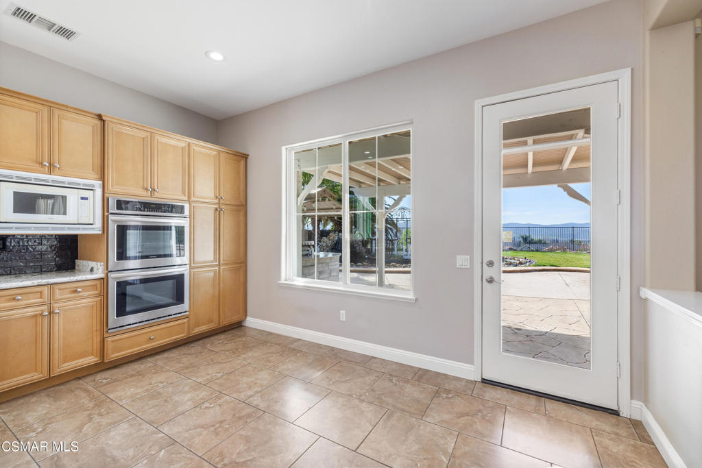 4920 Corral Street Simi Valley, CA 93063 - Photo 15 of 54 a kitchen with stainless steel appliances a stove and more cabinets