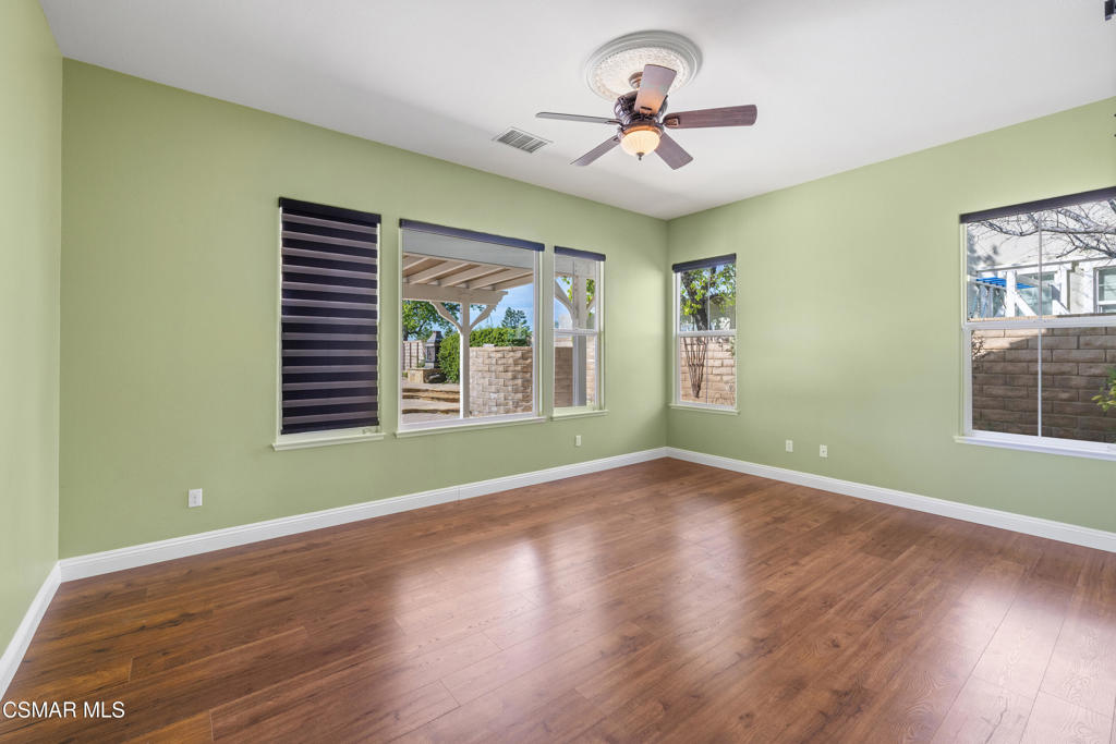 4920 Corral Street Simi Valley, CA 93063 - Photo 16 of 54 a view of an empty room with a window and wooden floor
