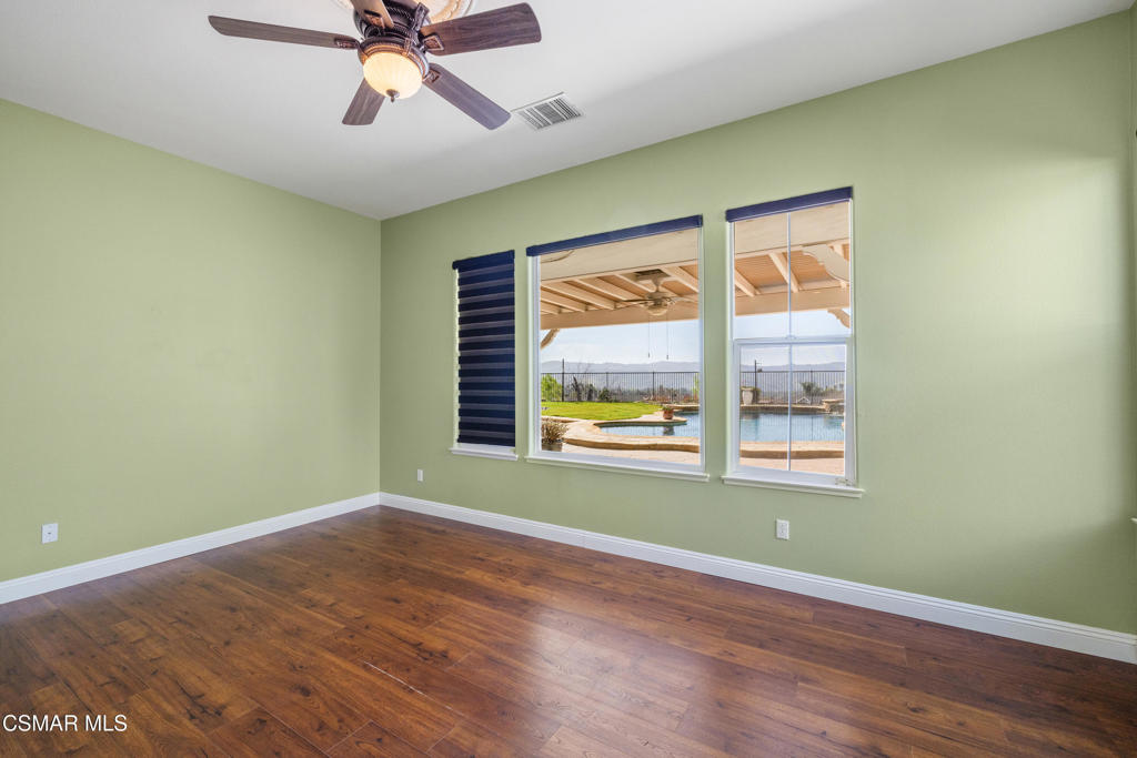 4920 Corral Street Simi Valley, CA 93063 - Photo 17 of 54 a view of an empty room with wooden floor and a window