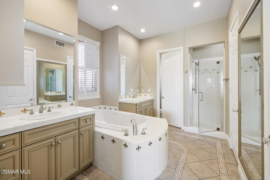 4920 Corral Street Simi Valley, CA 93063 - Photo 19 of 54 a spacious bathroom with a double vanity sink mirror and double
