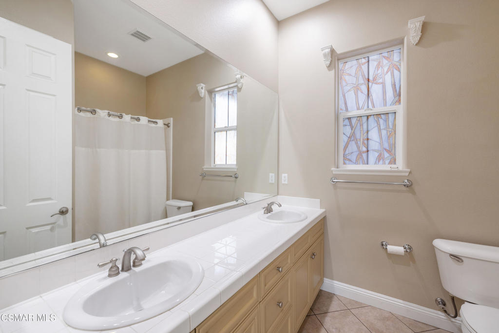 4920 Corral Street Simi Valley, CA 93063 - Photo 24 of 54 a bathroom with a sink double vanity and a window