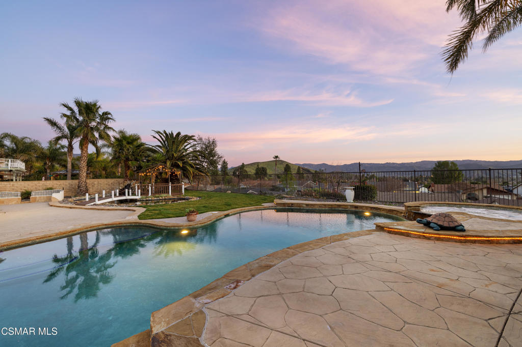 4920 Corral Street Simi Valley, CA 93063 - Photo 32 of 54 a view of a swimming pool with a table and chairs