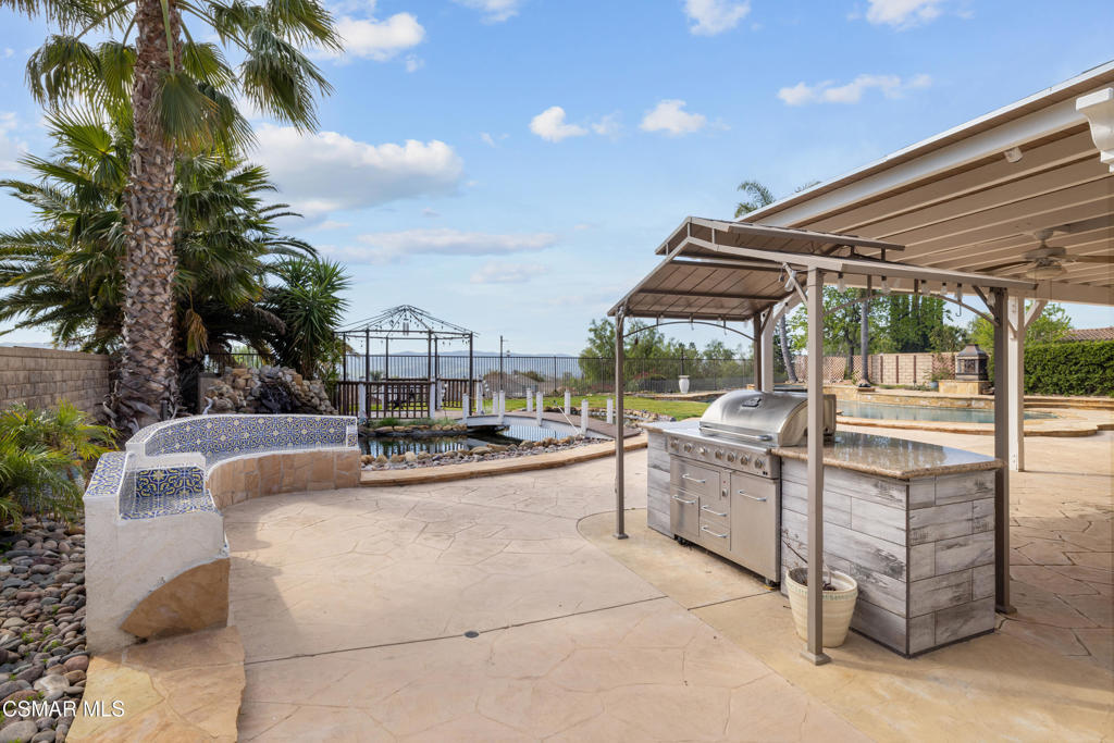 4920 Corral Street Simi Valley, CA 93063 - Photo 42 of 54 a view of a patio with couches and chairs under an umbrella
