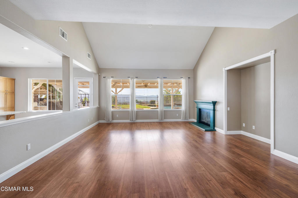 4920 Corral Street Simi Valley, CA 93063 - Photo 10 of 54 an empty room with wooden floor and windows