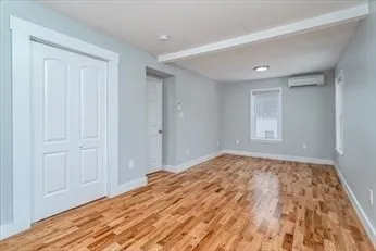 a view of a livingroom with wooden floor and closet