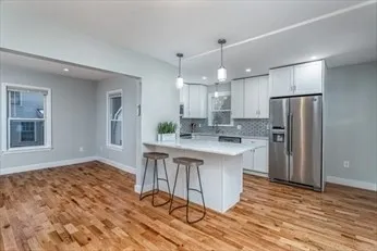 a kitchen with stainless steel appliances granite countertop a refrigerator and a sink