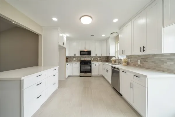 a large kitchen with cabinets