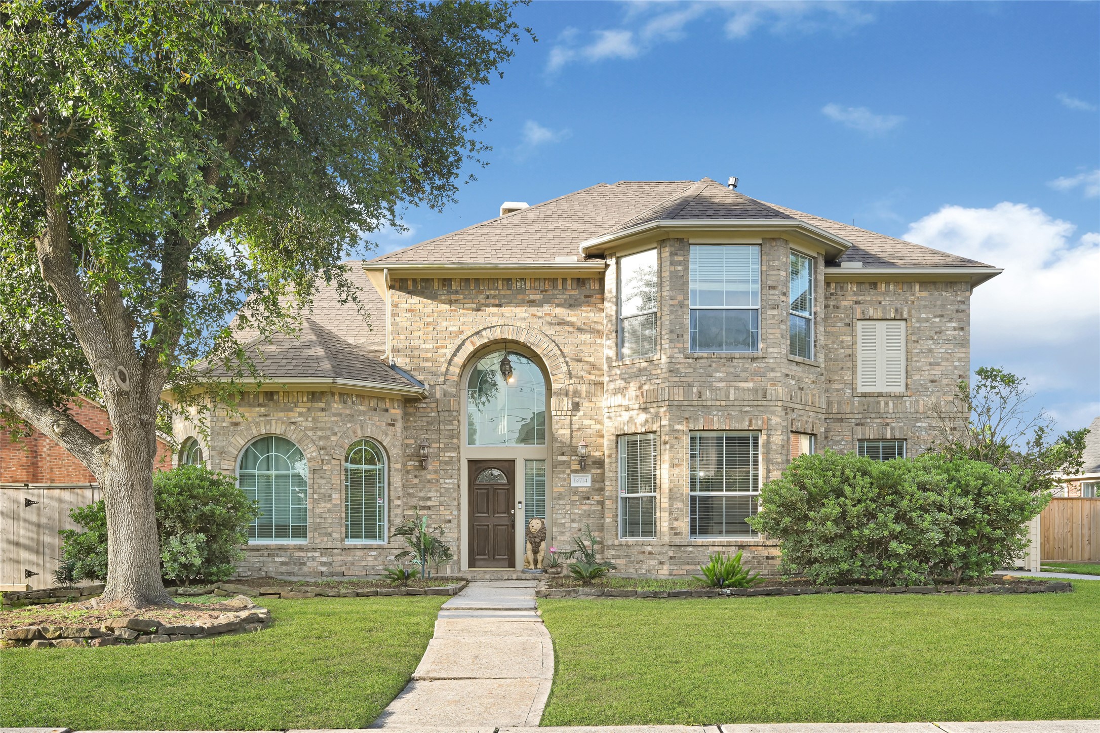 14714 Placid Point Humble, TX 77396 - Photo 2 of 37 This two-story brick home features large arched windows and a welcoming front entrance.