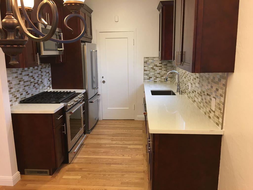 1217 Capuchino Avenue, Unit 1 Burlingame, CA 94010 - Photo 3 of 10 a kitchen with a sink stove and refrigerator