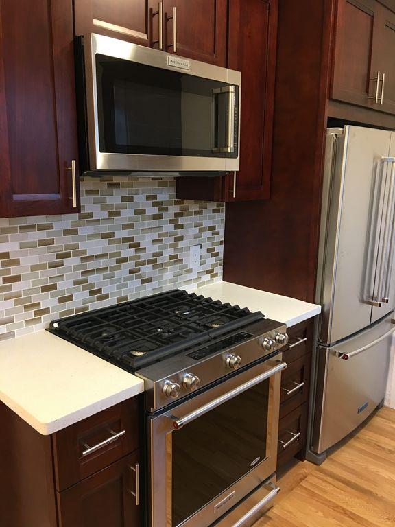 1217 Capuchino Avenue, Unit 1 Burlingame, CA 94010 - Photo 4 of 10 a stove top oven sitting inside of a kitchen