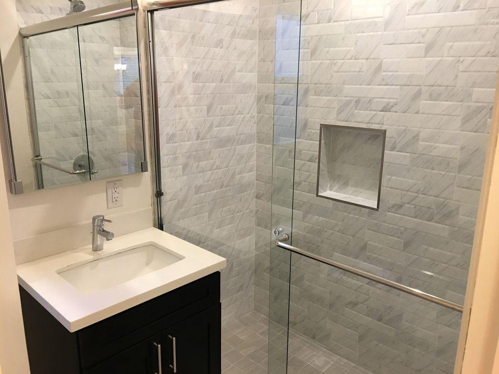 1217 Capuchino Avenue, Unit 1 Burlingame, CA 94010 - Photo 8 of 10 a bathroom with a sink mirror and a shower