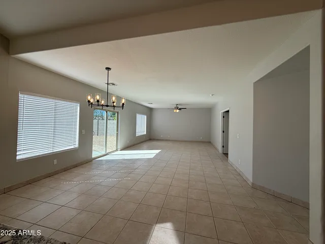 a view of a chandelier fan and entryway