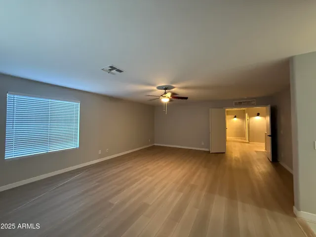 a spacious bathroom with a granite countertop sink a mirror and a