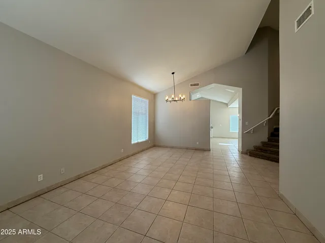a view of a livingroom with an empty space and a stove