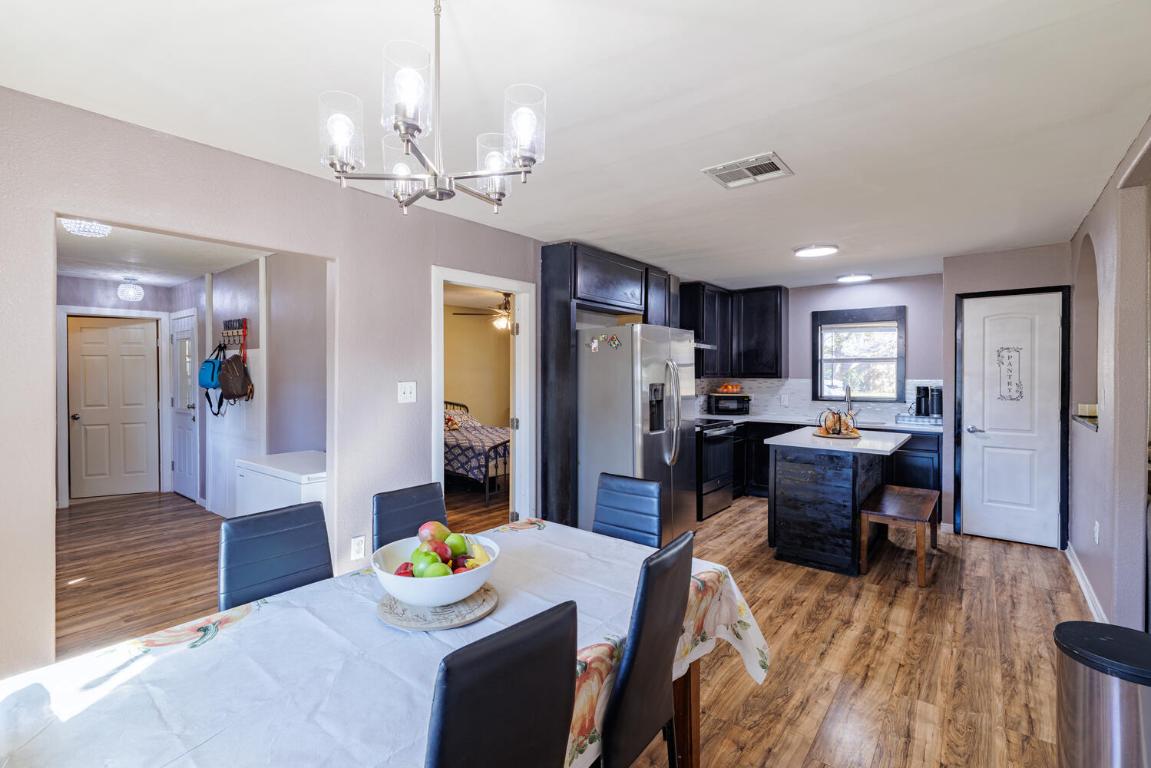 112 Maynard Street Bastrop, TX 78602 - Photo 14 of 35 Dining space with light wood finished floors, a chandelier, and a ceiling fan
