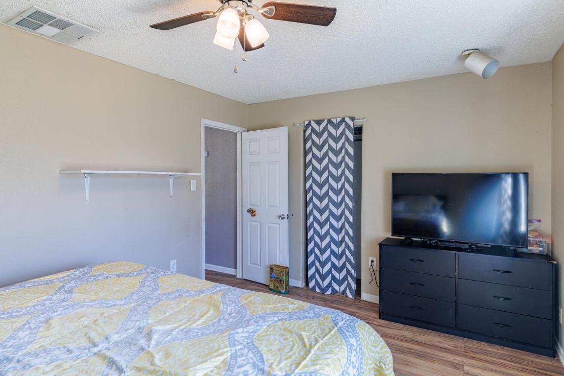 112 Maynard Street Bastrop, TX 78602 - Photo 22 of 35 Bedroom with wood finished floors, a textured ceiling, and a ceiling fan