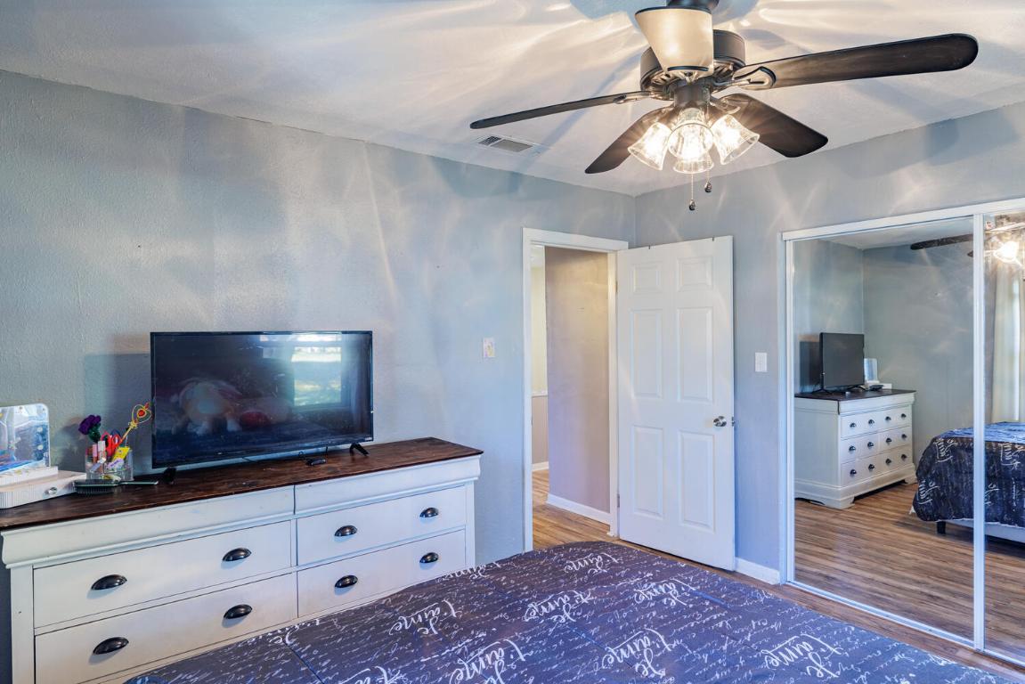 112 Maynard Street Bastrop, TX 78602 - Photo 24 of 35 Bedroom with wood finished floors, a closet, and a ceiling fan
