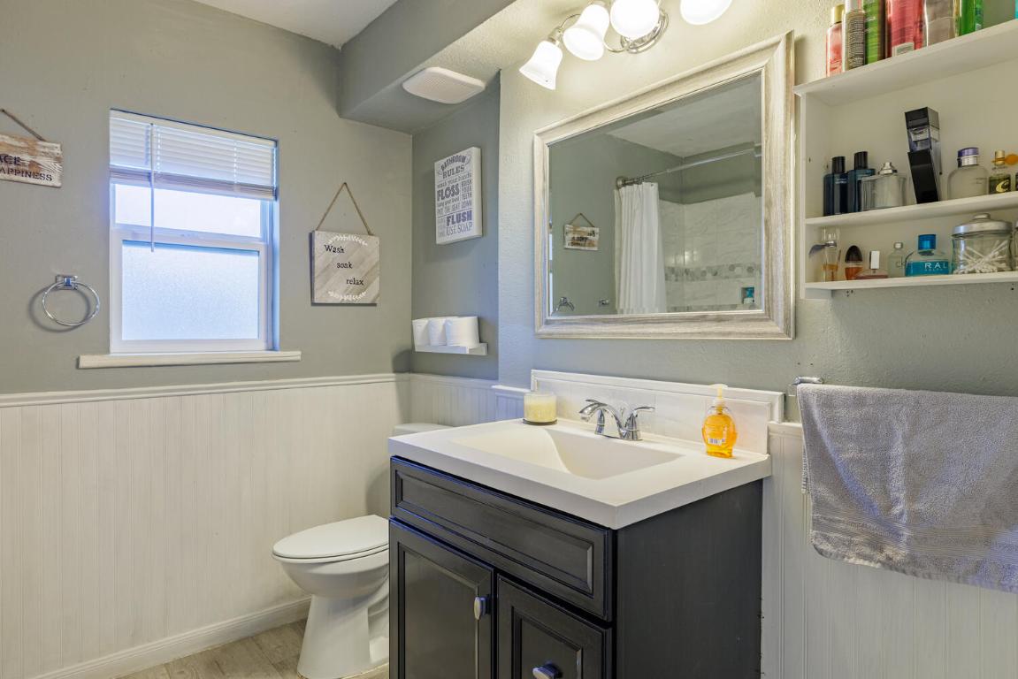 112 Maynard Street Bastrop, TX 78602 - Photo 25 of 35 Full bathroom with a wainscoted wall, vanity, a shower with curtain, and light wood-type flooring