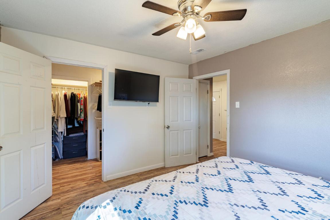 112 Maynard Street Bastrop, TX 78602 - Photo 28 of 35 Bedroom with light wood finished floors, a spacious closet, and a ceiling fan