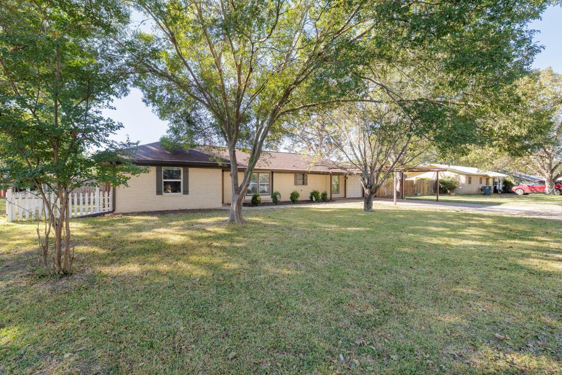 112 Maynard Street Bastrop, TX 78602 - Photo 3 of 35 Single story home featuring brick siding, driveway, and an attached carport
