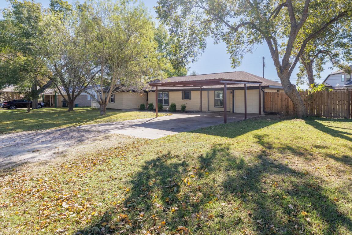 112 Maynard Street Bastrop, TX 78602 - Photo 4 of 35 Back of house with driveway, a patio area, and an attached carport