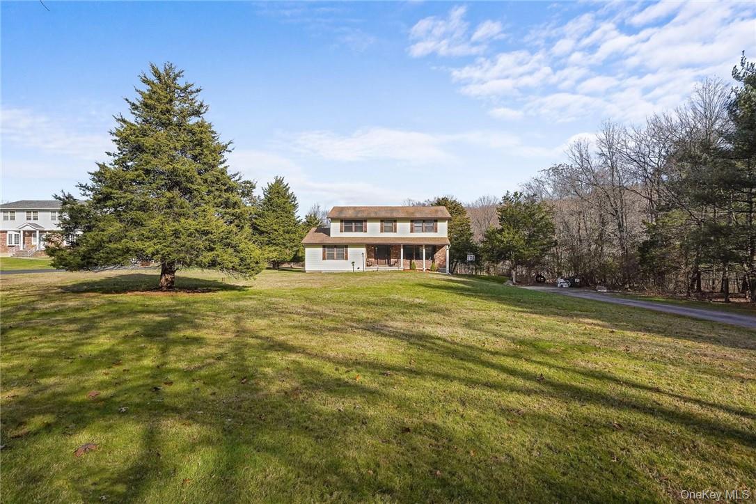 a view of a big yard with large trees