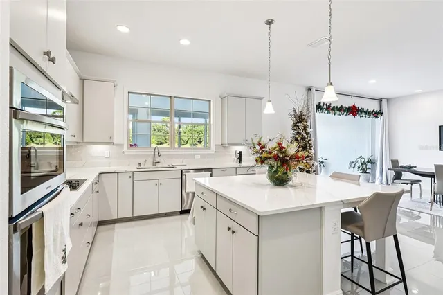 a spacious bathroom with a granite countertop sink and a white cabinet