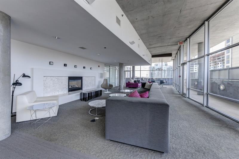 845 Spring Street Northwest, Unit 522 Atlanta, GA 30308 - Photo 15 of 23 a living room with furniture and a large window