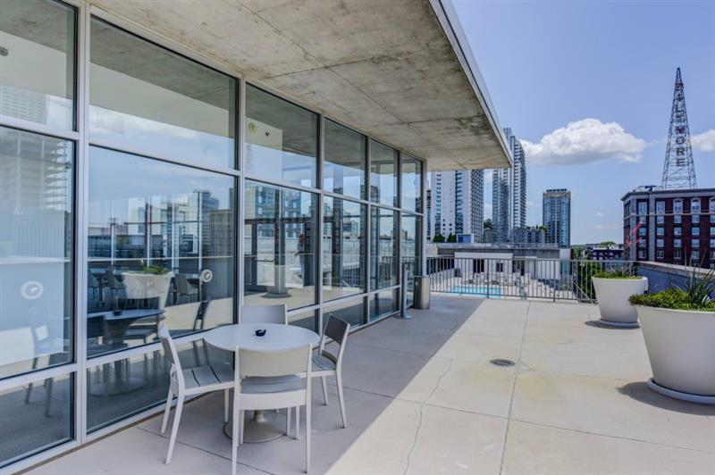 845 Spring Street Northwest, Unit 522 Atlanta, GA 30308 - Photo 16 of 23 a patio with a table and chairs