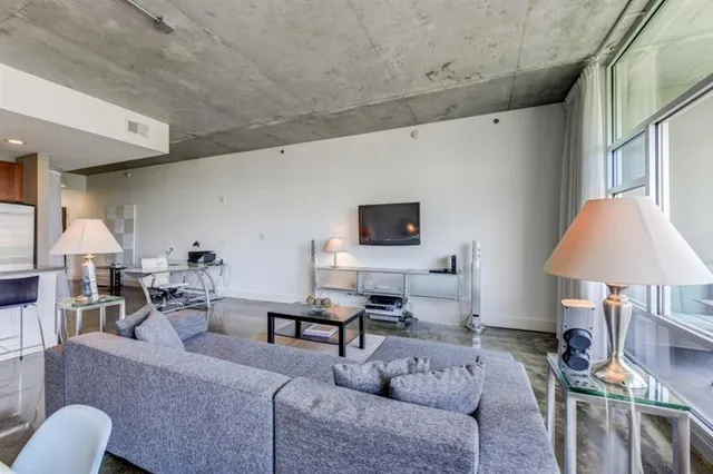 a living room with furniture and a lamp