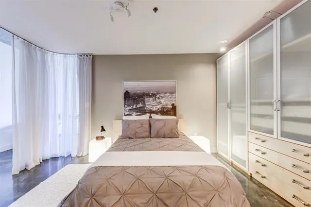 a bedroom with a large bed and a window