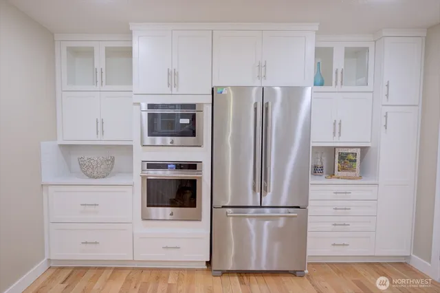 a white refrigerator freezer and a stove sitting inside of a kitchen