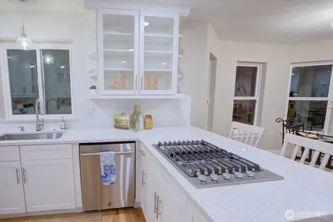 a kitchen with a stove and white cabinets